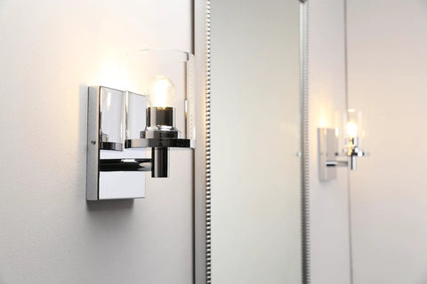 Super Cool Vintage Style One Light Wall Sconce With Clear Glass Shade And Metal Base In Chrome shown from side view in bathroom