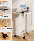 Adjustable Pneumatic Standing Desk On Wheels With Lockable Casters Mobile Laptop Desk Overbed Bedside Table For Home Office 28 Inch Wide By 16 Inch Deep White, showing steel frame and wheels.