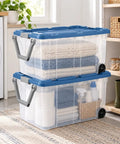 Premium Heavy Duty Wheeled Storage Bins 160 Quart 2 Pack with clear boxes holding towels in a laundry room.