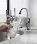 Top Shelf One Handle Low Arc Chrome Faucet For Countertop With Lead Free Drinking Water Flow pouring water into a glass.
