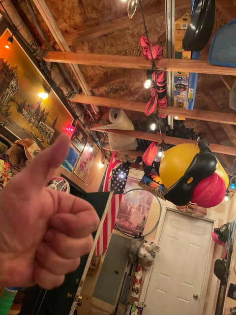 Thumbs up in a cluttered garage with various hanging items and wall decorations. No Clear S14 LED String Light Bulbs 2W scene visible.