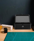Small Iron Toolbox Featuring A Snug Metal Clasp For Portable Hand Carry Home Projects And Road Trip Trunk Organization on a wooden workbench.