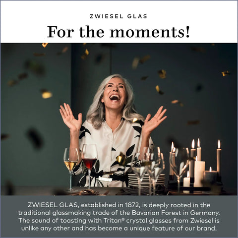 Woman celebrating with Tritan crystal glasses, surrounded by candles and confetti, showcasing Zwiesel Glas elegance.