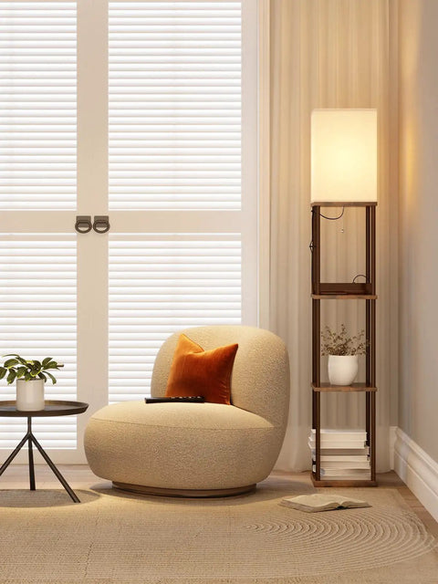 Shelf Floor Lamp With 2 USB Ports And Power Outlet next to a chair in a living room, brown finish.
