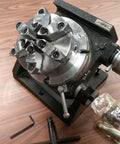 Precision Tilting Rotary Table With Six Jaw Self Centering Chuck For Dead Nuts Angular Control And Clean Sweeps On Cnc Or Manual Mill Rigs Gear Drives Zero To Ninety Degrees For That Top Shelf Accuracy, complete with accessories.