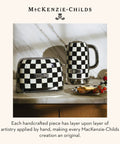 Electric Kettle With Stainless Steel Body In Black And White Courtly Check Pattern For Quick Boiled Water A Game Changing Pick For Tea Or Coffee In A Modern Kitchen next to matching toaster on counter
