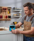 Man using Magnetic Cabinet Door Hinge Spacer With Scale No Drill Quick Install Jig for Precise Door Installation on cabinet in workshop.