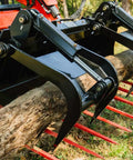 72 Inch Manure Tine Grapple Bucket Attachment with SSQA Hay Spear Frame clamping log, showing twin cylinders and red tines