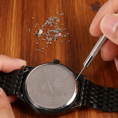 Hands using tool with 100 Piece Watch Screw Set With Micro Battery Clamp Screws, Stainless Steel Assortment For Watchmaking And Repair