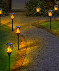 Solar Tiki Torch Lights With Flickering Flame Outdoor LED Lamp Waterproof For Yard Patio Garden And Porch Landscape Decor Solar Powered Lights illuminating a pathway at night