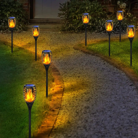 Solar Tiki Torch Lights With Flickering Flame Outdoor LED Lamp Waterproof For Yard Patio Garden And Porch Landscape Decor Solar Powered Lights illuminating a pathway at night