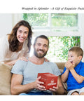 Family smiling with man holding wrapped gift box indoors