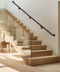 Solid Black Aluminum Stair Handrail DIY Kit With ADA Compliant Wall Returns No Sweat Installation Powder Coated For Indoor Outdoor Walkways Slick Five Foot Grip Bar on modern wooden staircase.