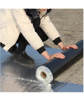 Kick Moisture In The Trash With This Heavy Duty Self Adhesive Bitumen Roofing Membrane Roll designed for leak tight patchwork, being unrolled.