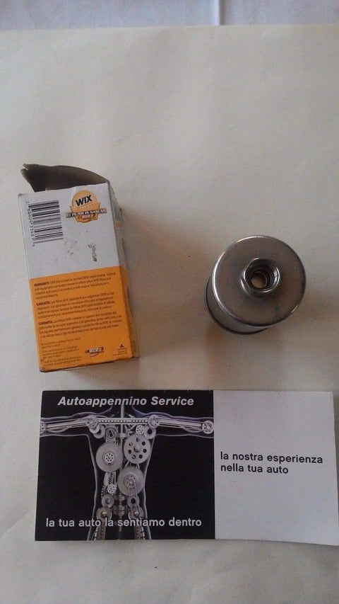 Premium Fuel Filter For Clean Fuel System, Quick And Easy Replacement, shown with packaging and service card on table