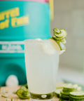 Close-up of a Retro 2 Gallon Party Water Jug Cooler Jade Finish With Eco Friendly THERMECOOL Foam Insulation, next to a drink.