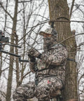 Hunter using Stiff Arm Tree Camera Arm Mount, Lightweight Aluminum With 360 Tool-Less Leveling in forest setting