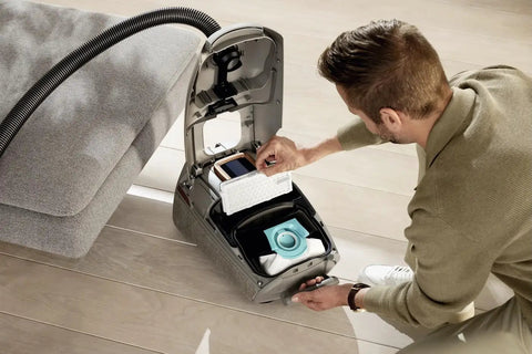 Man installing Genuine HEPA AirClean Filter SF HA 50 in vacuum for improved air quality