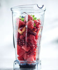 64-Ounce Blender Jar Replacement With Drip-Free Spout, Vented Lid And Measuring Cap filled with fresh fruits