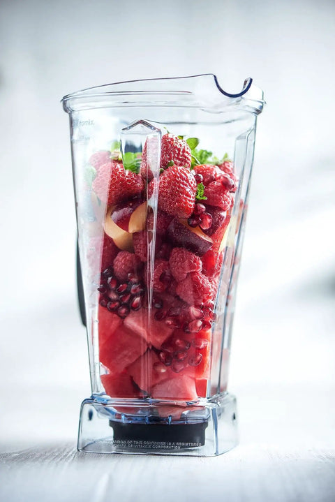 64-Ounce Blender Jar Replacement With Drip-Free Spout, Vented Lid And Measuring Cap filled with fresh fruits