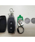 Key fob with open case, two CR2016 lithium batteries, metal keyring, flat surface