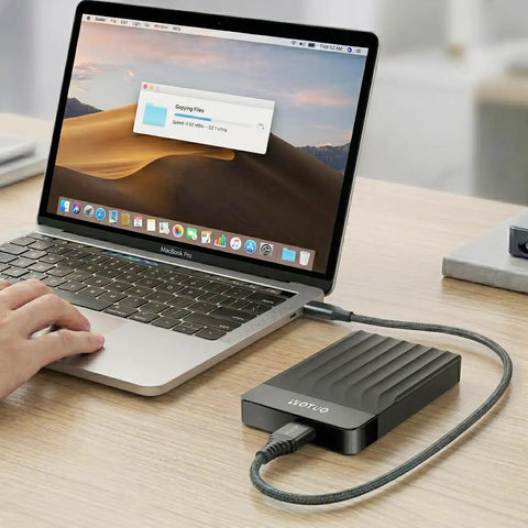 Person using MacBook with Portable External Hard Drive 1TB USB 3.0 USB-C Storage Expansion for PC Mac Desktop Laptop