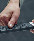 Close-up of hands holding Rainfinity 2 Inch Modern Handheld Shower Head With PowderRain Jet Chrome Finish 1 Spray 2.5 GPM