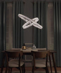 Hella Sharp Six Light Ceiling Pendant With Glossy Polished Chrome Trim And Classic Beveled Crystal Glass Shades, illuminating a dining area.