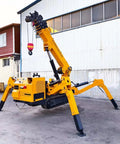 Mini Crawler Lifting Equipment With Telescopic Boom For Compact Crane Tasks next to a building showing stable outriggers