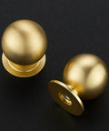 Round Ball Cabinet Knobs For Dresser And Kitchen, Brushed Brass 0.95 Inch Diameter, Zinc Alloy Hardware, two knobs on black surface