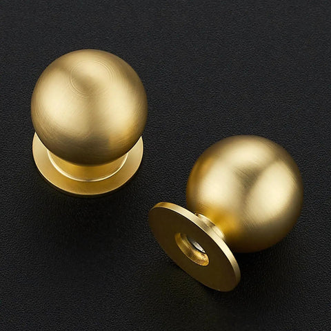 Round Ball Cabinet Knobs For Dresser And Kitchen, Brushed Brass 0.95 Inch Diameter, Zinc Alloy Hardware, two knobs on black surface