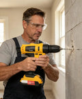 Man using Heavy Hitter Cordless Power Drill And High Torque Workhorse for drilling in concrete wall, wearing safety goggles.