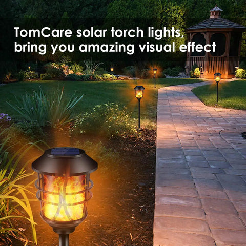 Solar Torch Lights Outdoor Flickering Flame Lit Set Of 4 Metal Pathway Lights Waterproof Landscape Decor Auto On Off Dusk Till Dawn For Patio Garden Yard Pool installed along a garden path.