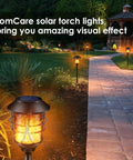 Solar Outdoor Torch Lights Set Of 4 Flickering Flame Metal Torches Waterproof Heavy Duty Pathway Lighting in a garden setting