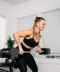 Woman using Sport 24 Straight Bar for Adjustable Dumbbell System, 33 Inch Length with 28mm Knurled Grip, in home workout
