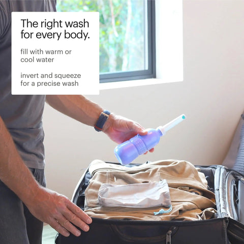 Person packing GoSpa Travel Bidet GS 70 Portable Peri Bottle in suitcase