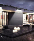 Modern house exterior with 62 LED Solar Wall Lights With Motion Sensor Outdoor Security Lighting illuminating the patio at night