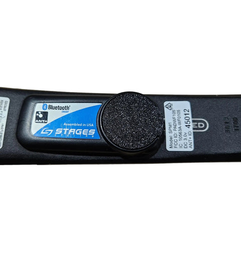 Close-up of Power Meter Battery Door For Left Side Gen 2 And Gen 3 Crank Fits Stages Power Meter Replacement Made In USA From High Quality Plastic With O Ring Seal Built Like A Tank on crank arm.