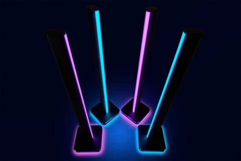 Add A 422mm Smart Lighting Tower With 46 Custom LEDs To Level Up Your RGB Setup And Flood Your PC Desk With Immersive Diffused Color Lighting For Gaming Rigs And Workstations, showing four towers emitting blue and purple light.