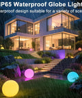 Cordless 16 Inch LED Glowing Ball Light With Remote RGB Color Changing Waterproof Glow Ball illuminating a rainy garden