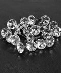 A Total Knockout Thirty Piece Set Of Twenty Five Millimeter Diamond Crystal Upholstery Tacks With Silver Plated Nails displayed on black leather.