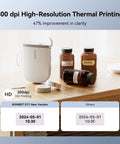 Compact Thermal Label Printer 300DPI High Resolution Portable Label Maker With Adhesive Tape Rolls For Home And Business Organization on a wooden table.