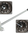 Heavy Duty Hub Oil Seal Remover Tool For Trailers And Trucks with rubber handle and metal tip next to hub seal in use
