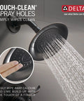 Windemere 14 Series Shower Faucet Set in oil rubbed bronze spraying water, showing Touch-Clean spray holes for easy cleaning.
