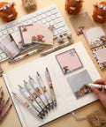 Highland Cow Desk Accessories Set With 9 Cute Sticky Notes And 9 Totally Cute Kawaii Pens 3x3 Inch Notepads on a desk.