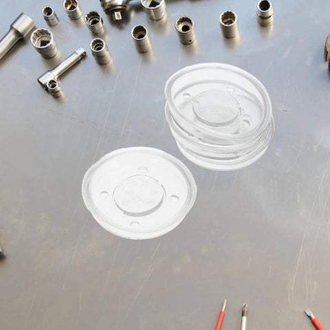 Four Piece Pitcher Pump Gasket Set For Hand Water Pumps White PVC Sealing Gaskets on metal surface with tools
