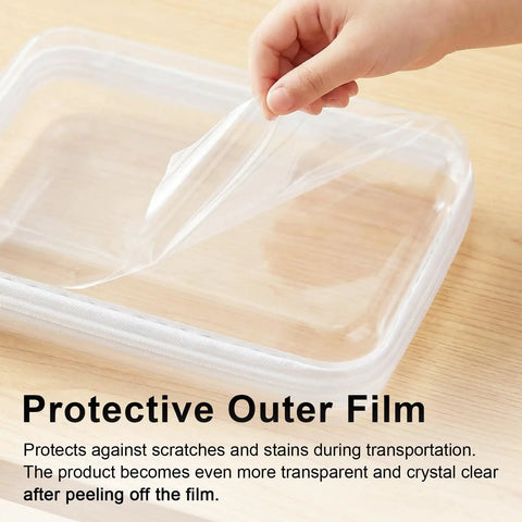 Hand peeling protective film off a Must Have Clear Hard Shell Zipper Case Three Pack Large 9.84 Inches By 7.87 Inches By 2 Inches.
