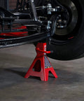 Red 2-ton Torin steel car jack stand under a vehicle wheel