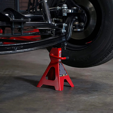 Red 2-ton Torin steel car jack stand under a vehicle wheel
