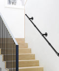 Straight Up Reliable Black Industrial Pipe Handrail Heavy Duty Steel Staircase Banister installed alongside wooden stairs.